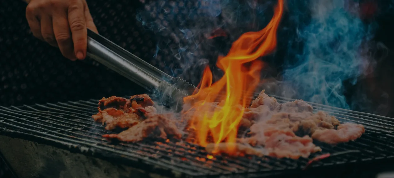 Meat over the embers on the grill