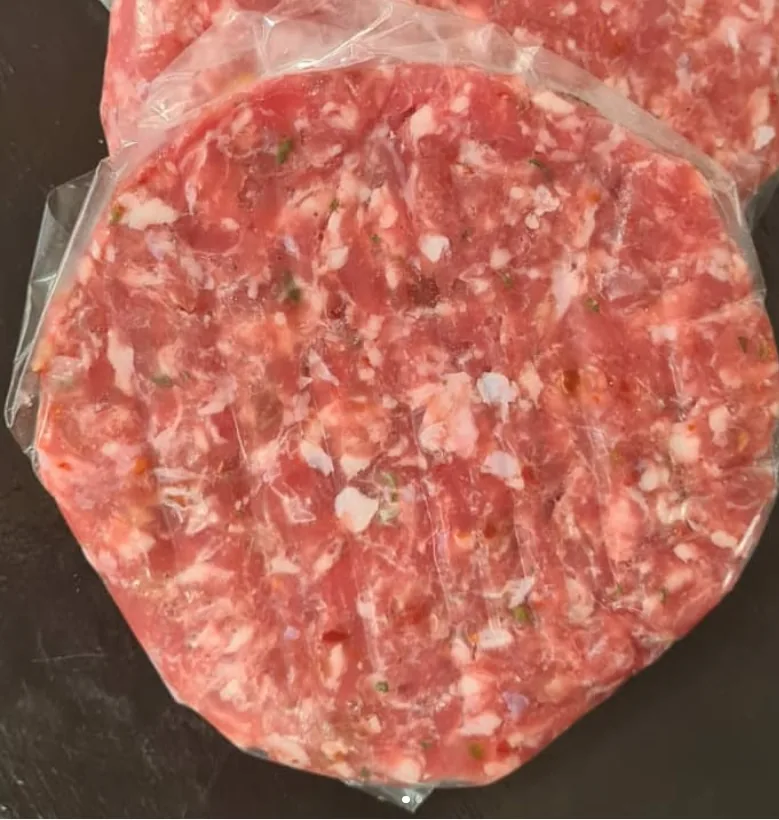 Raw beef burger with cut marks