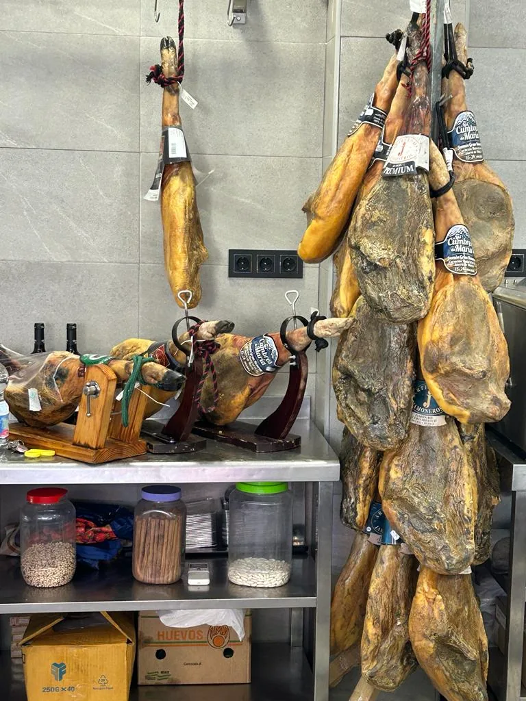 Hanging hams and ham stand at Carnicería Lorga