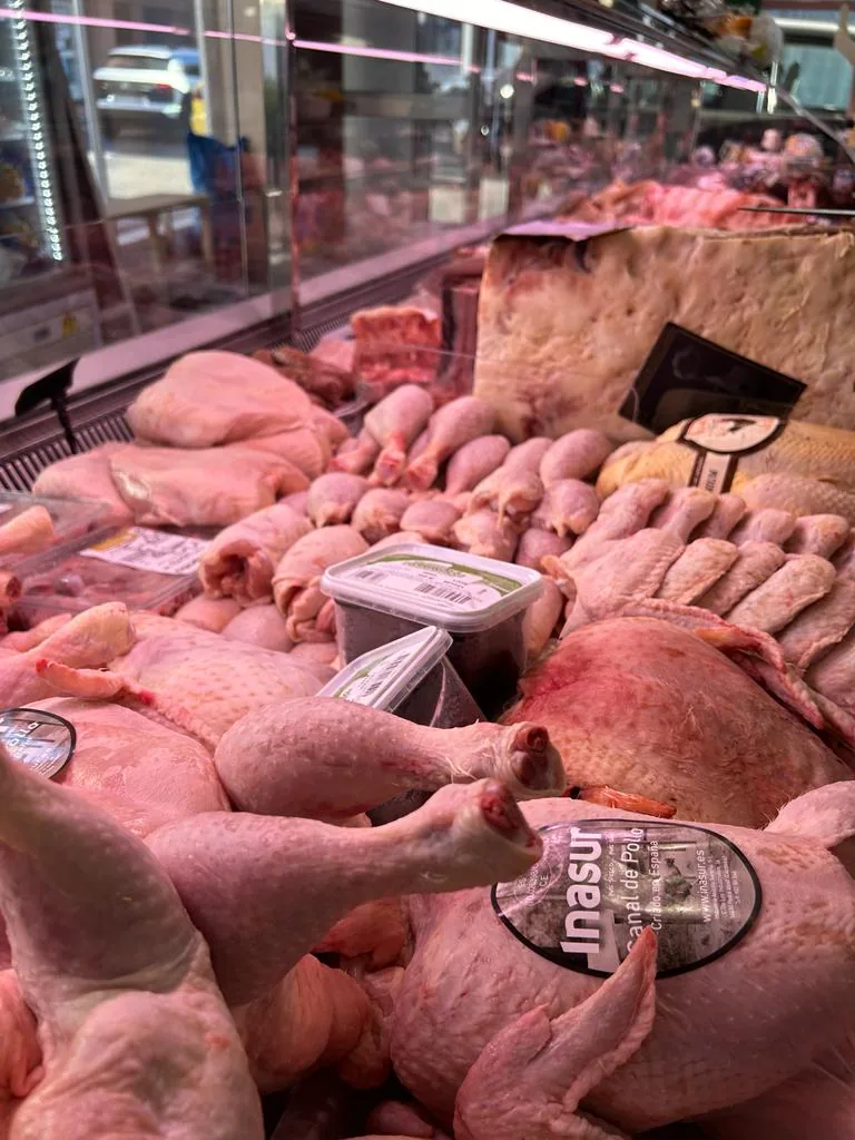 Pollo fresco en el mostrador refrigerado de Carnicería Lorga